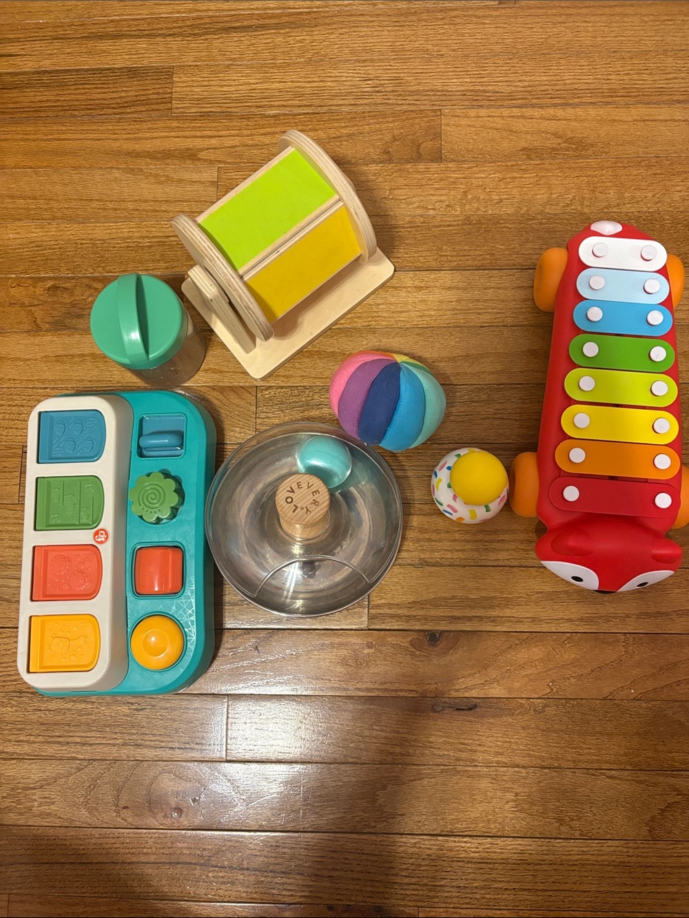 5 Lovevery Toys, 1 Skip Hop toy, 1 Fisher Price toy